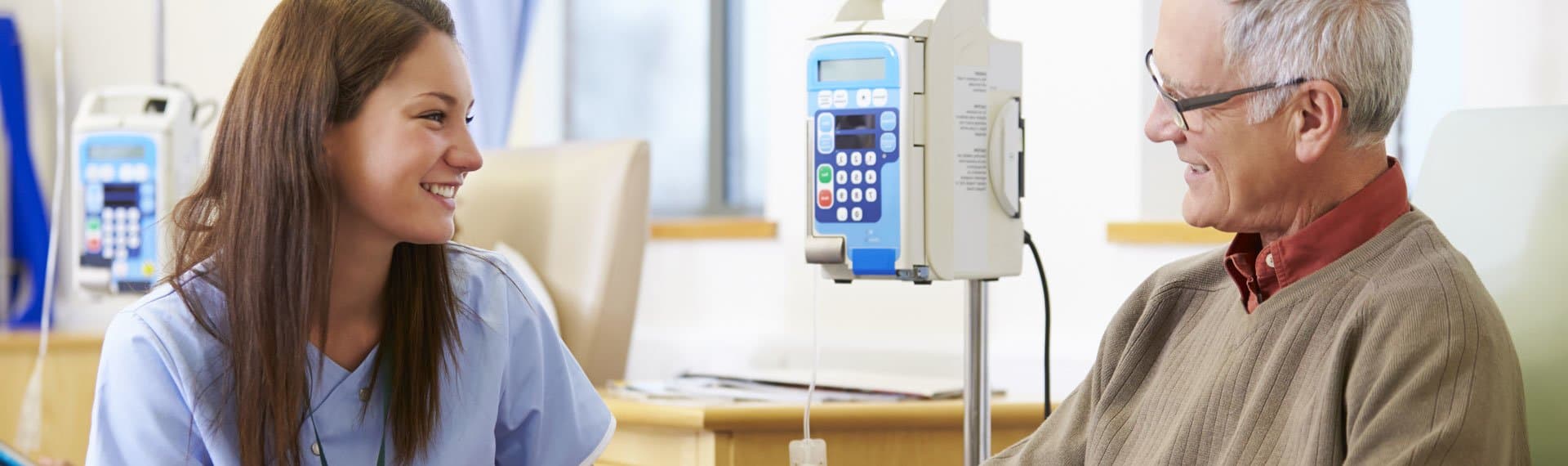 Image of doctor visiting with elderly patient