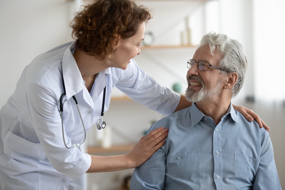 A female doctor caring for an elderly patient