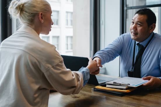 A doctor shaking hands with a candidate during a job interview