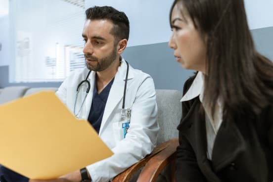 A doctor guiding a student during a clinical learning session