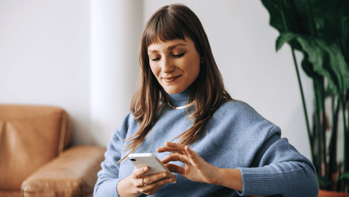 A young woman using her smartphone to schedule a medical appointment