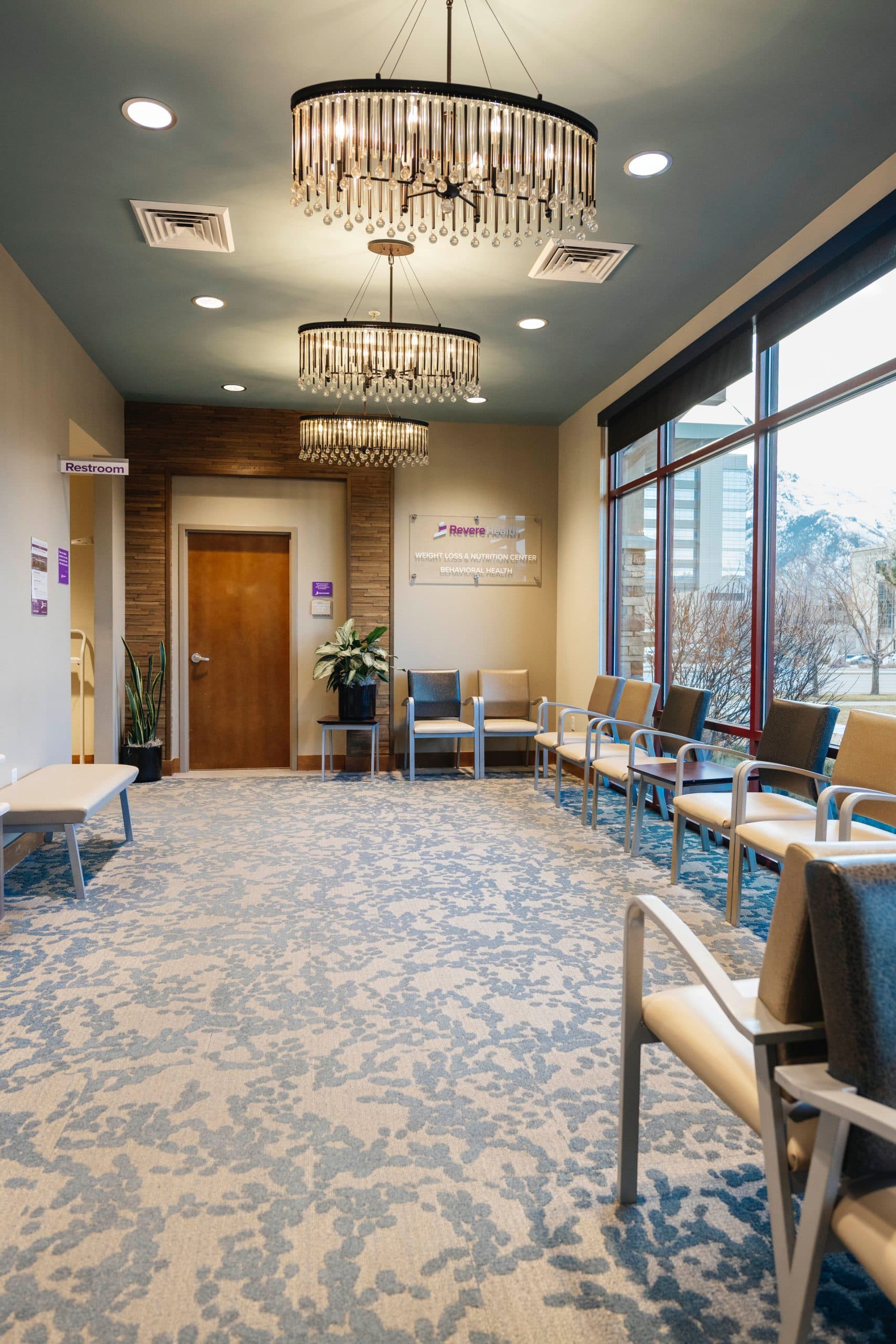 Waiting area with signage for Revere Health Weight Loss and Nutrition, featuring seating and welcoming lighting.