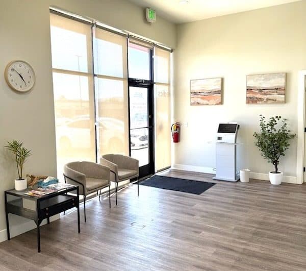 Image of Bright reception area with modern furnishings, natural light, and a welcoming check-in station.