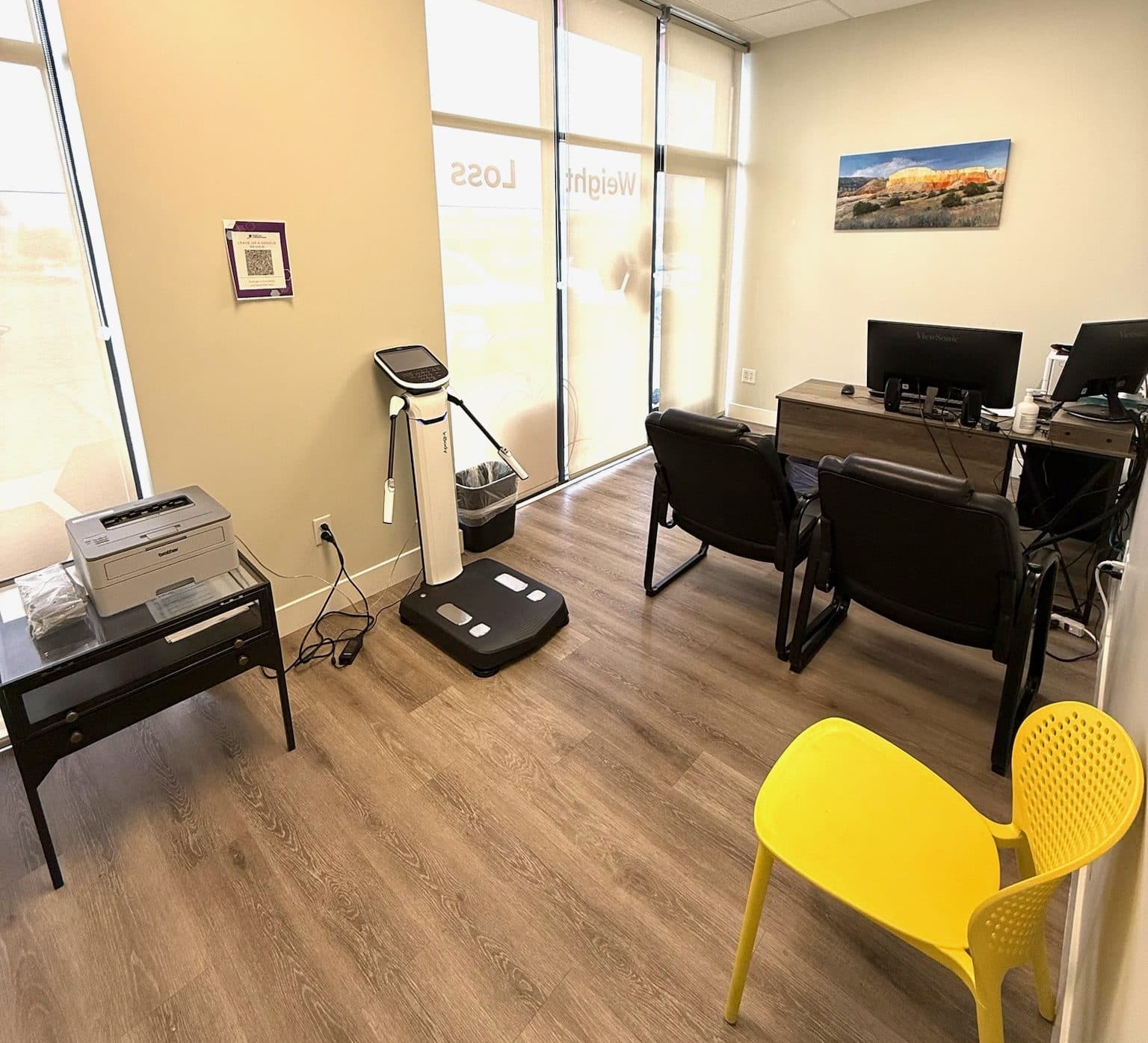 Image of Private consultation space featuring a body composition scale and seating, used for wellness check-ins and patient evaluations.