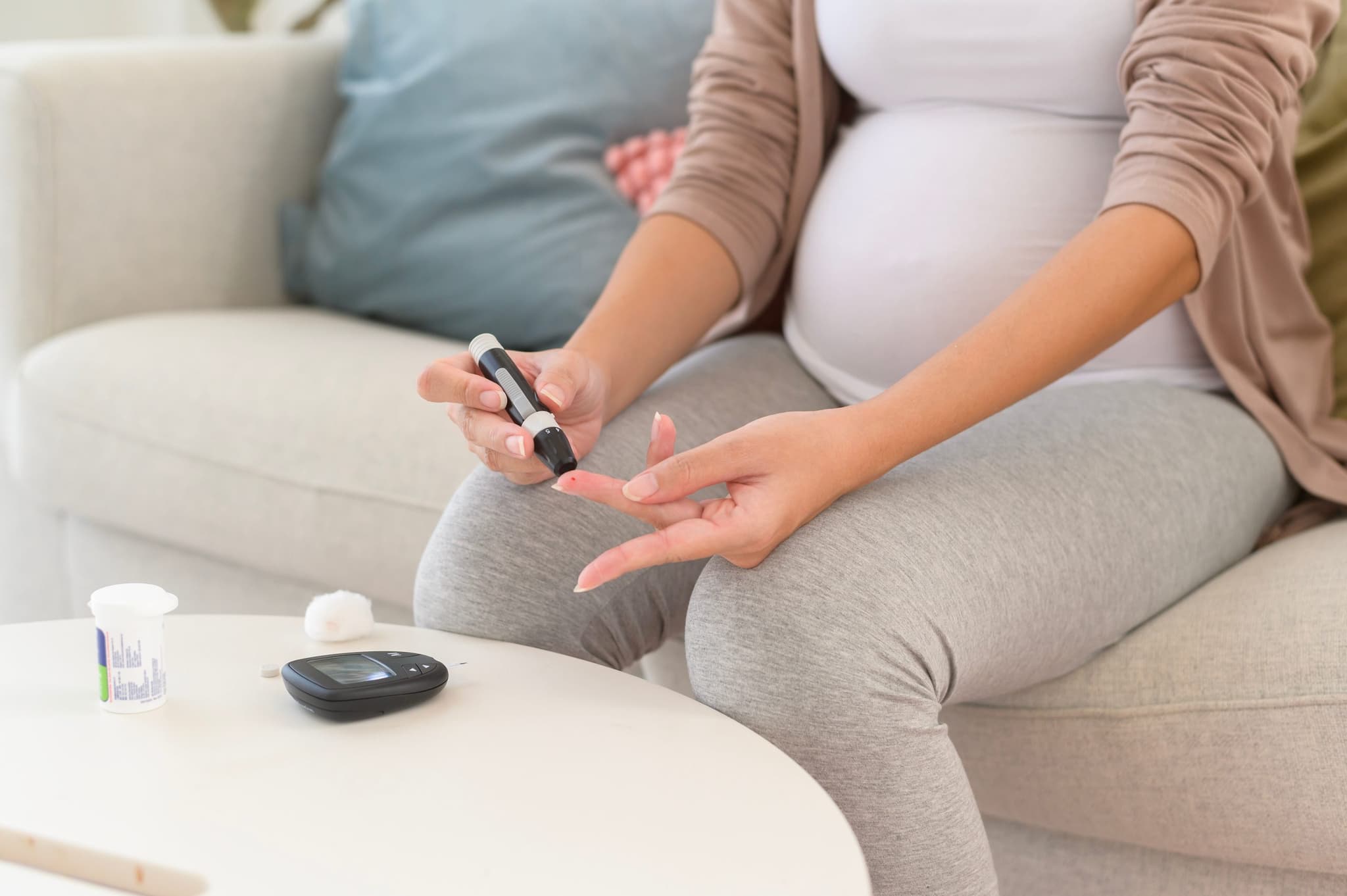 Picture of Pregnant woman checking blood sugar level by using Digital Glucose meter, health care, medicine, diabetes, glycemia concept