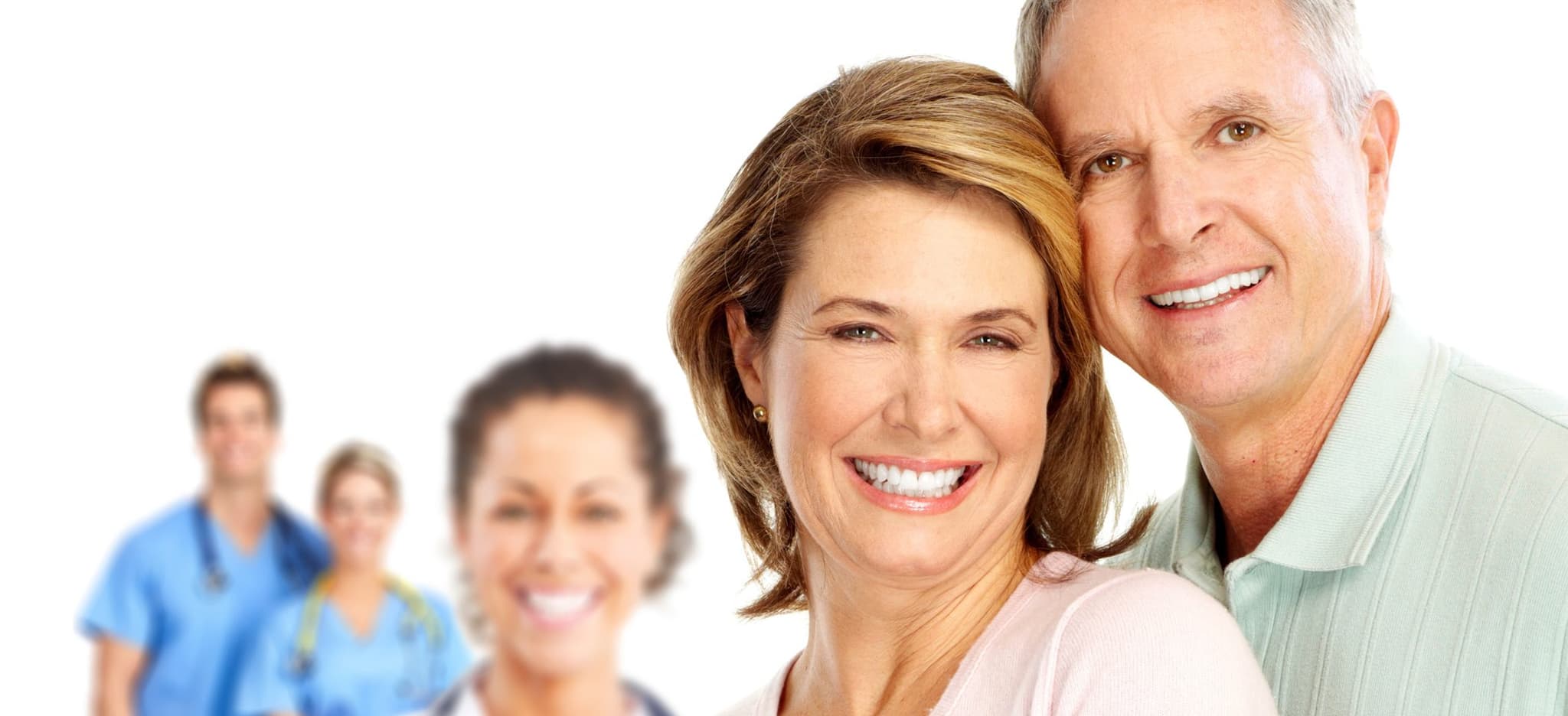 Picture of smiling couple with doctors in background