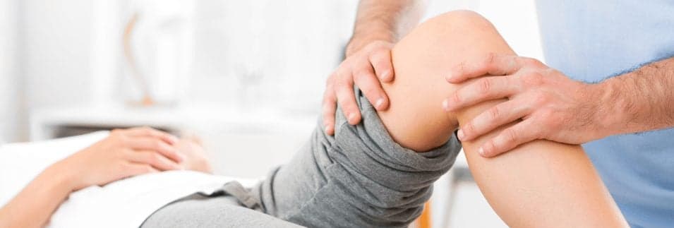 Picture of Young attractive woman being helped by physiotherapist