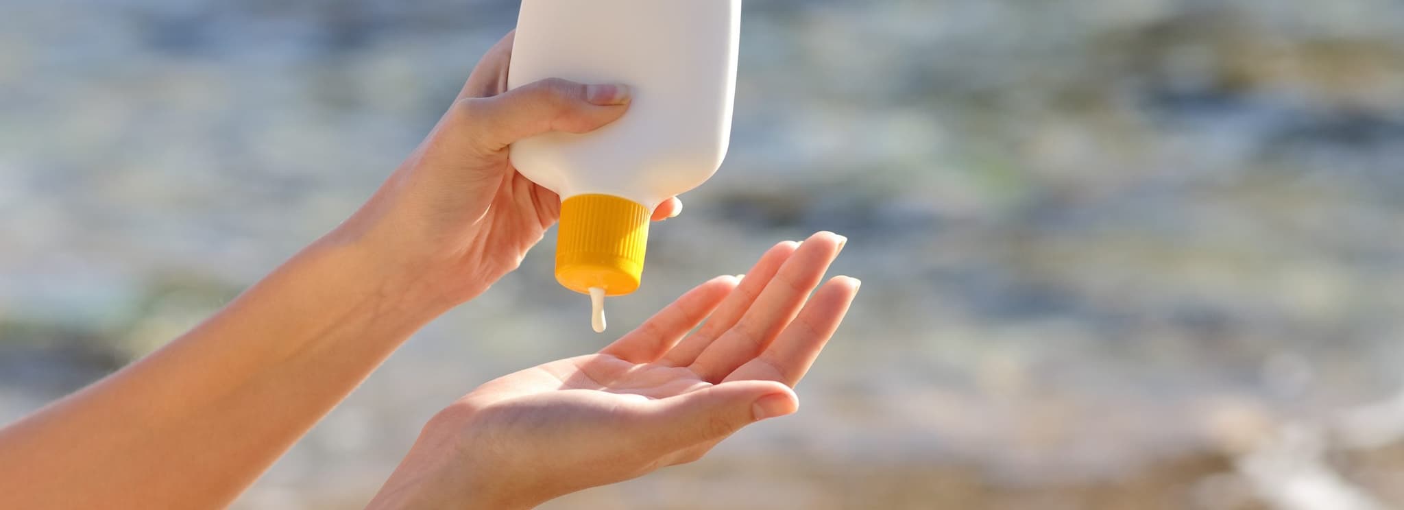 Picture of Person putting on sun tan lotion