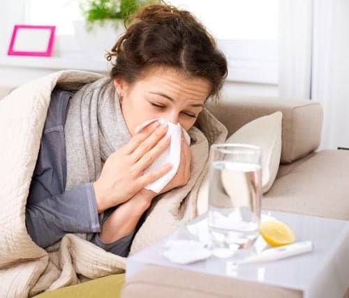 Picture of Flu or Cold. Sneezing Woman Sick Blowing Nose