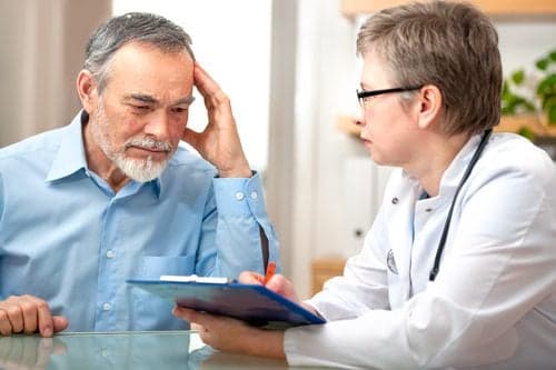 Picture of doctor explaining things to a confused older patient