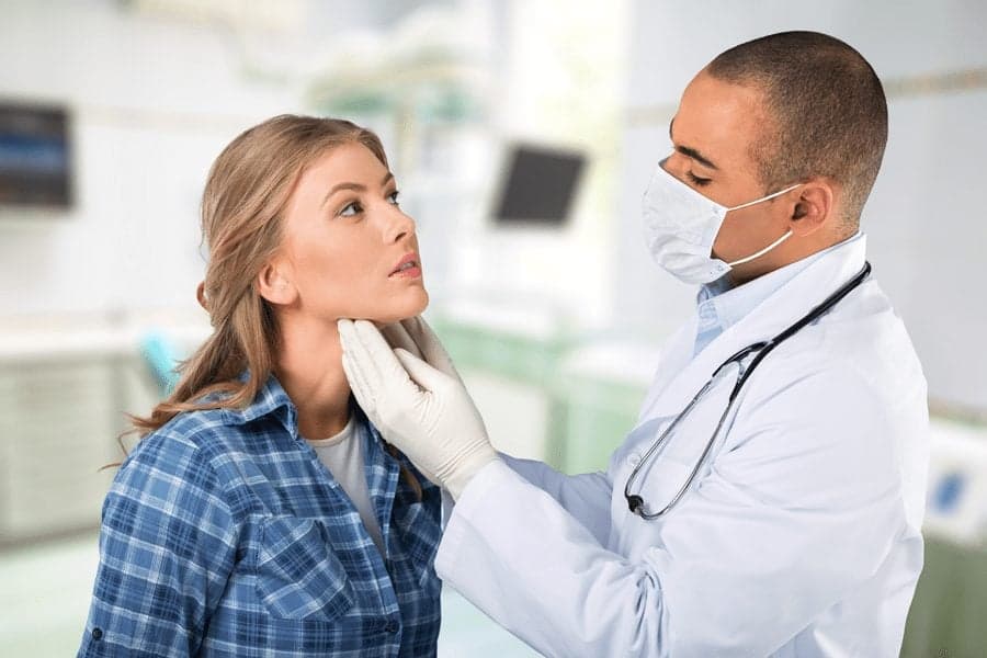doctor examining patients neck