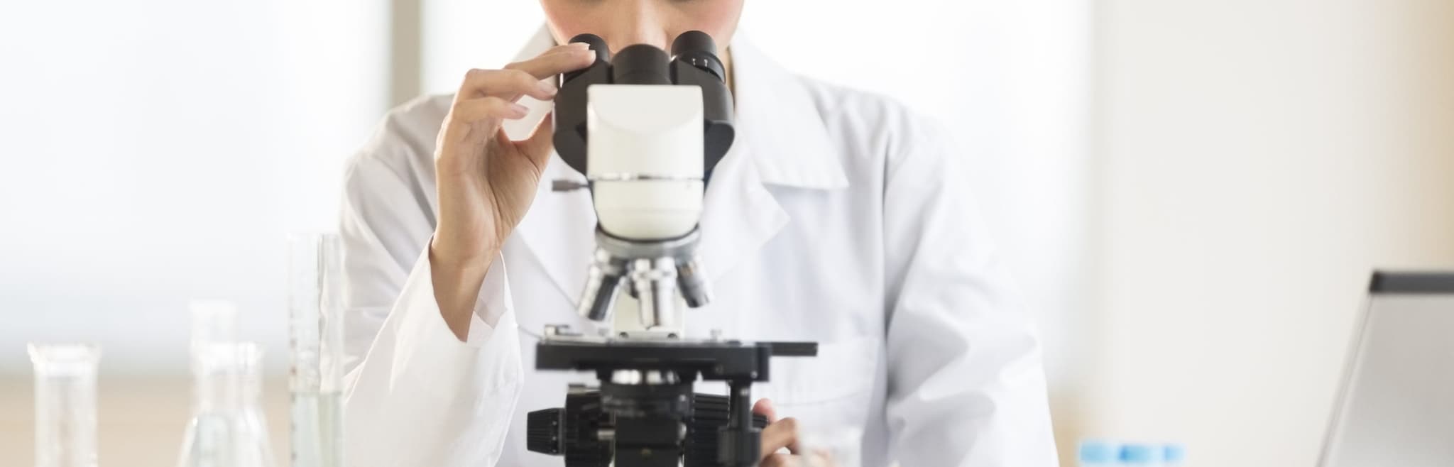 Picture of Woman looking through microscope
