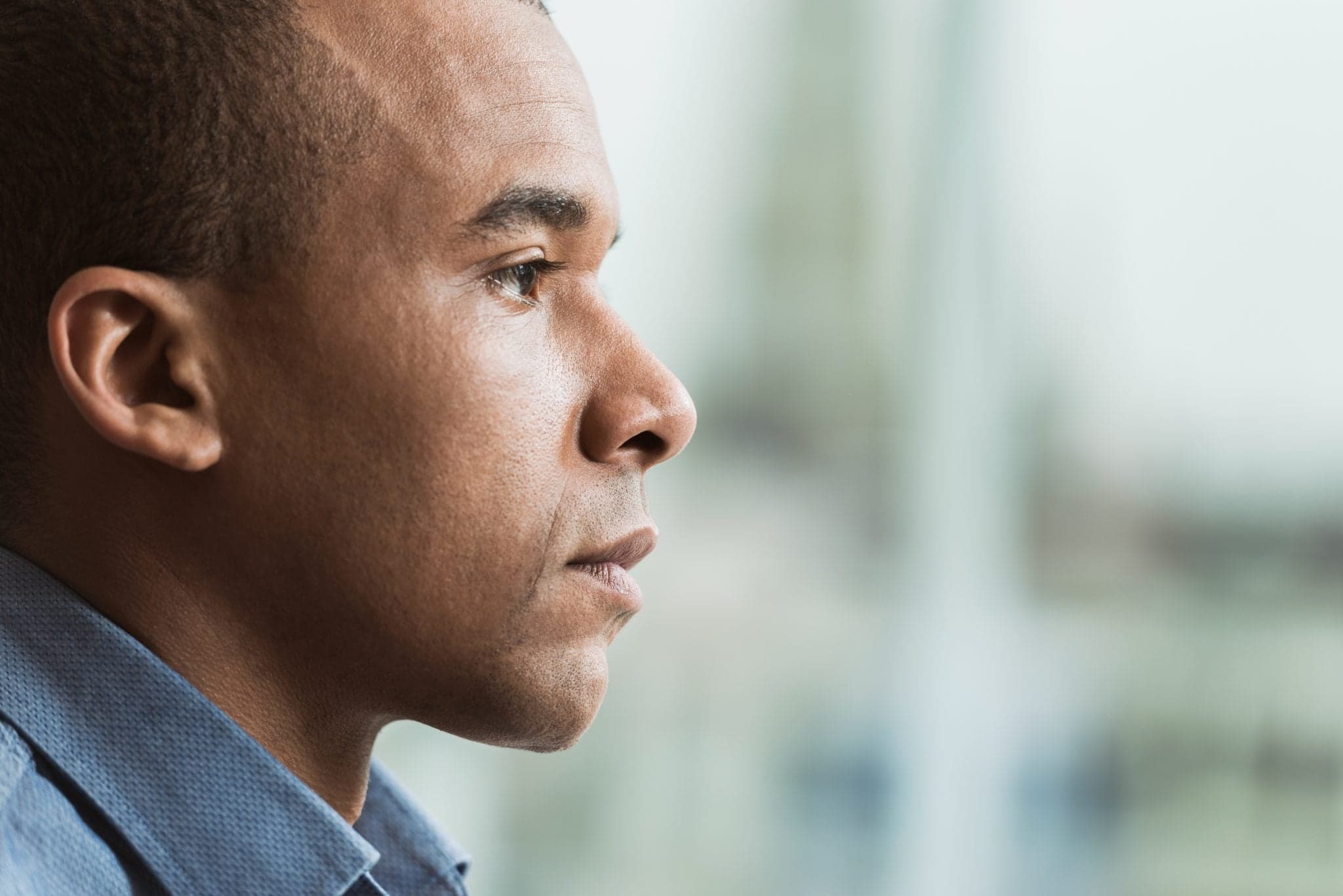 Picture of Side view of pensive African American businessman.