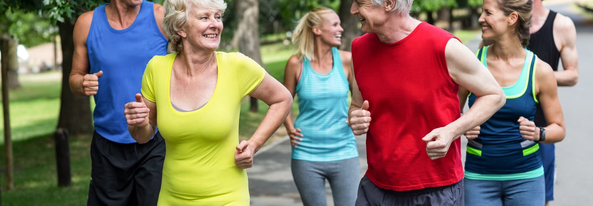 Picture of elderly couple jogging with group