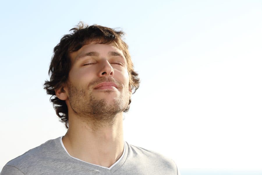 man breathing in happily
