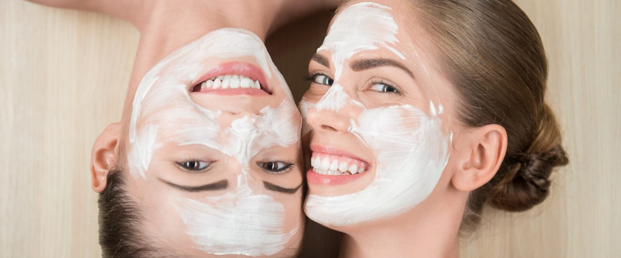 Picture of two woman laying on floor with facials on