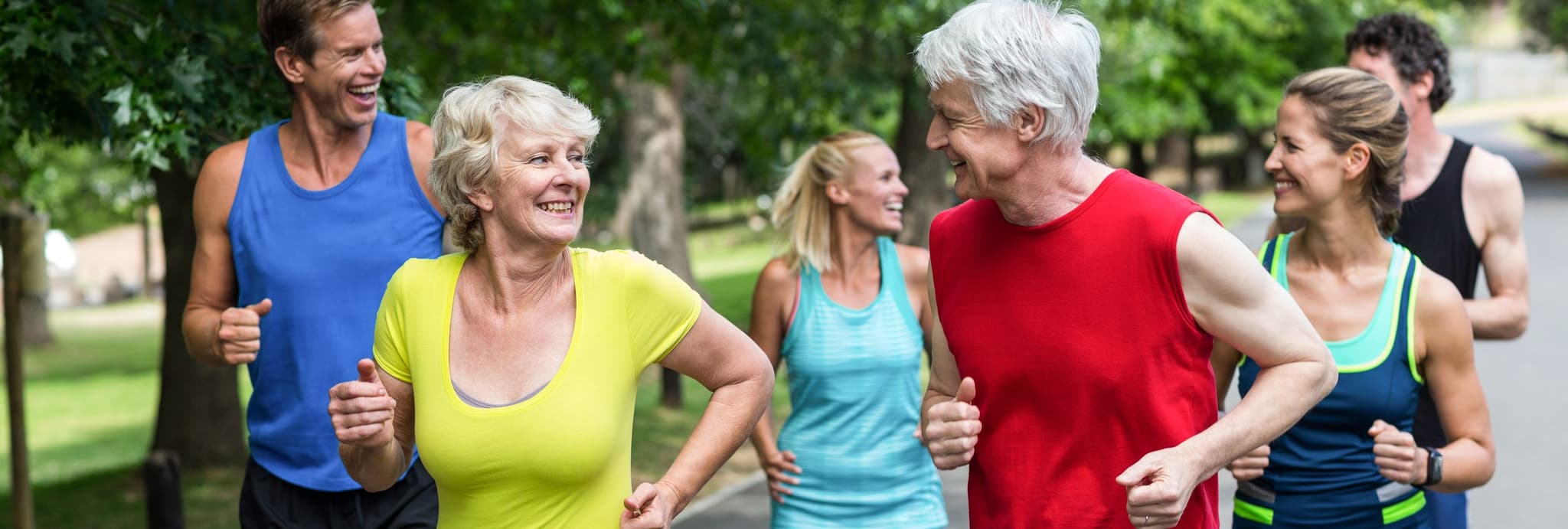 Picture of elderly couple jogging with group