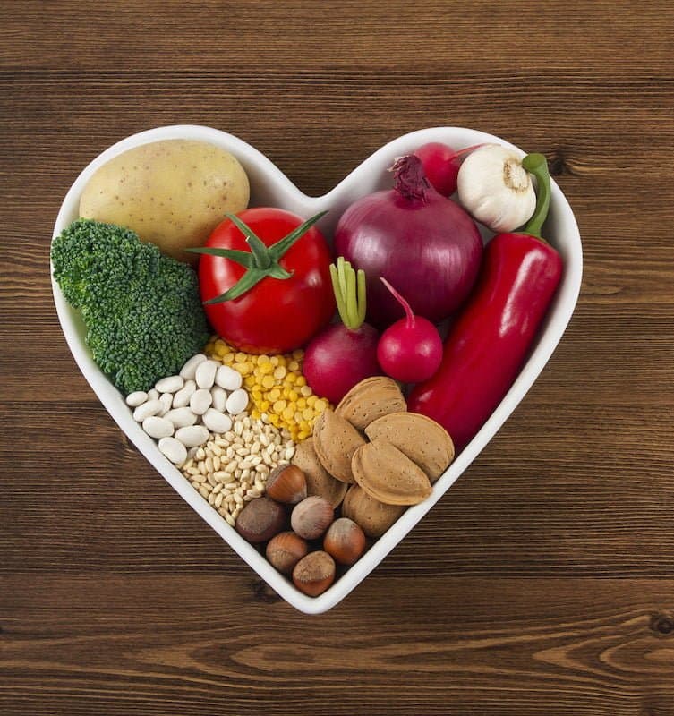 Healthy Foods in Heart Shaped Bowl on Wooden Table