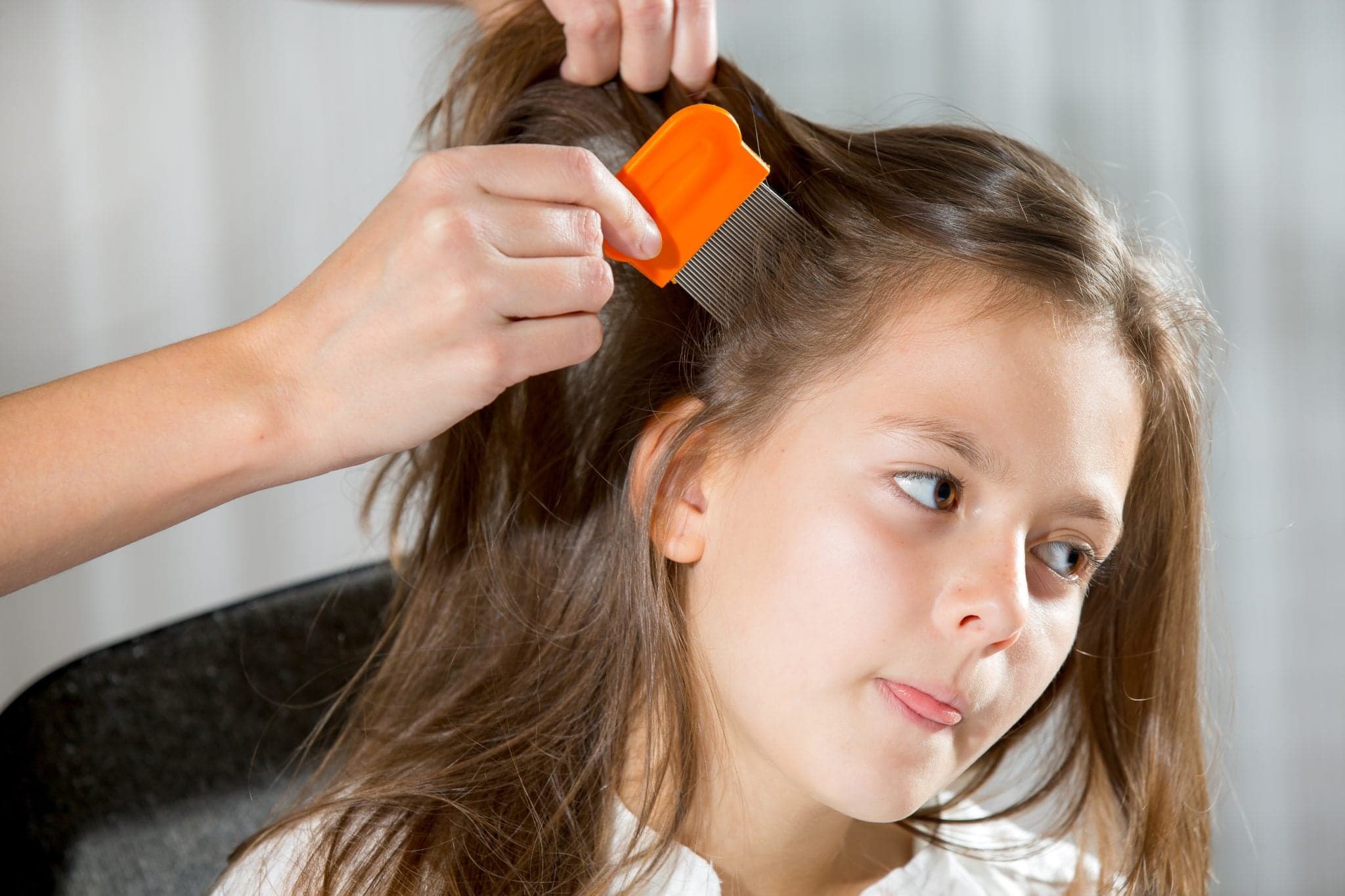 Picture of A mother using a comb to look for head lice