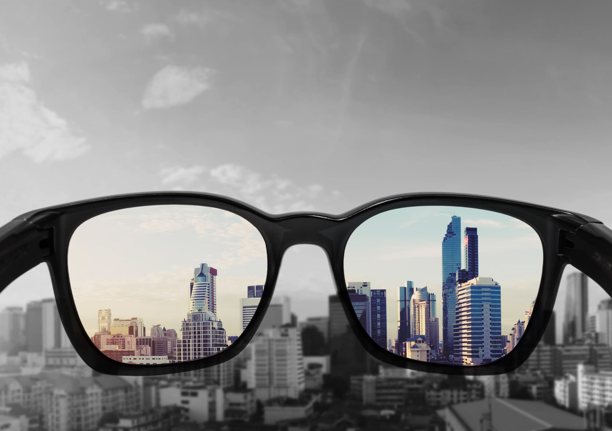 Picture of Eye glasses looking to city view, focused on glasses lens