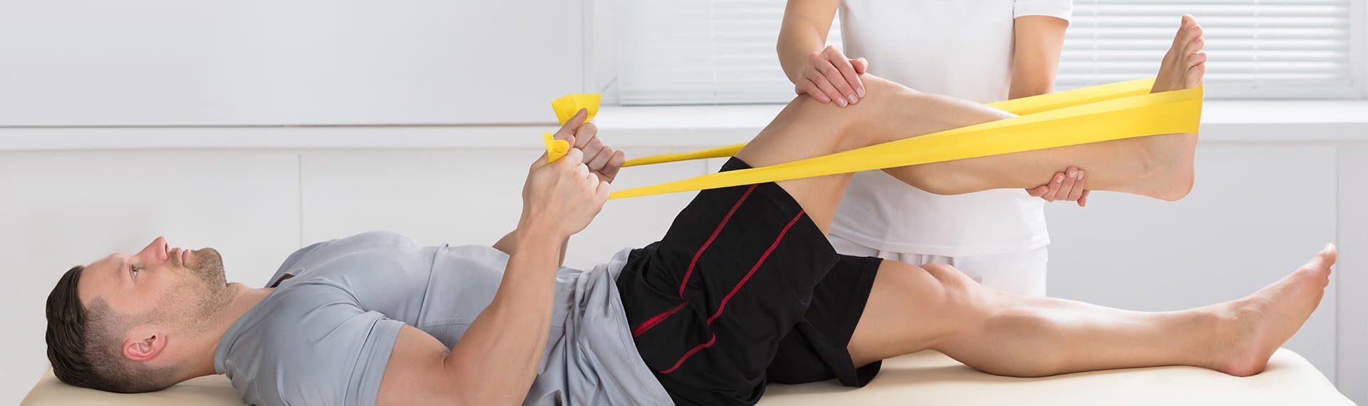 doctor helping patient with physical therapy