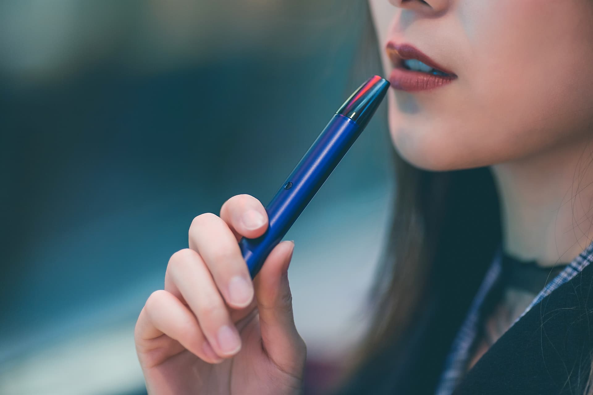 Picture of woman holding blue vape