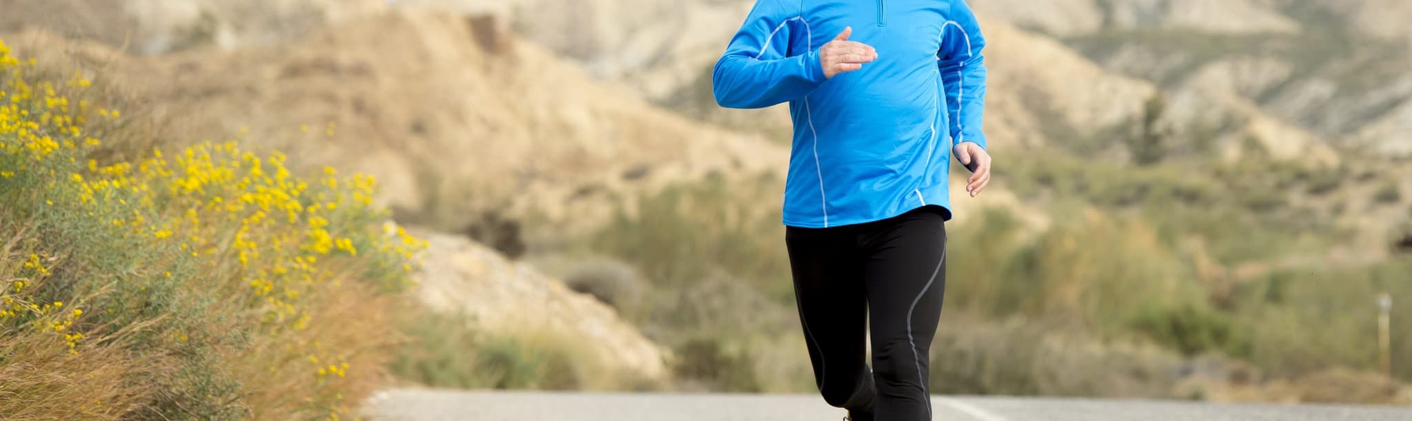 Picture of man jogging down road