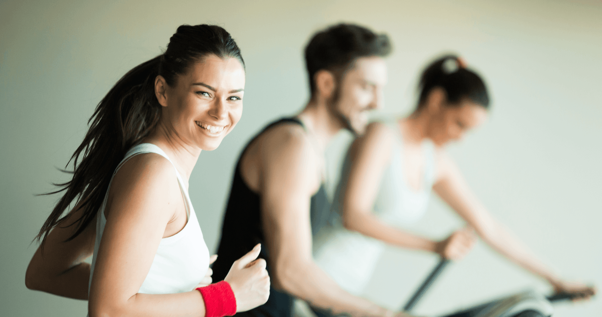 Picture of smiling woman running in gym