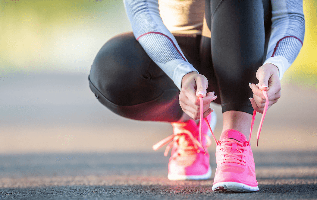 Image of woman tying shoes