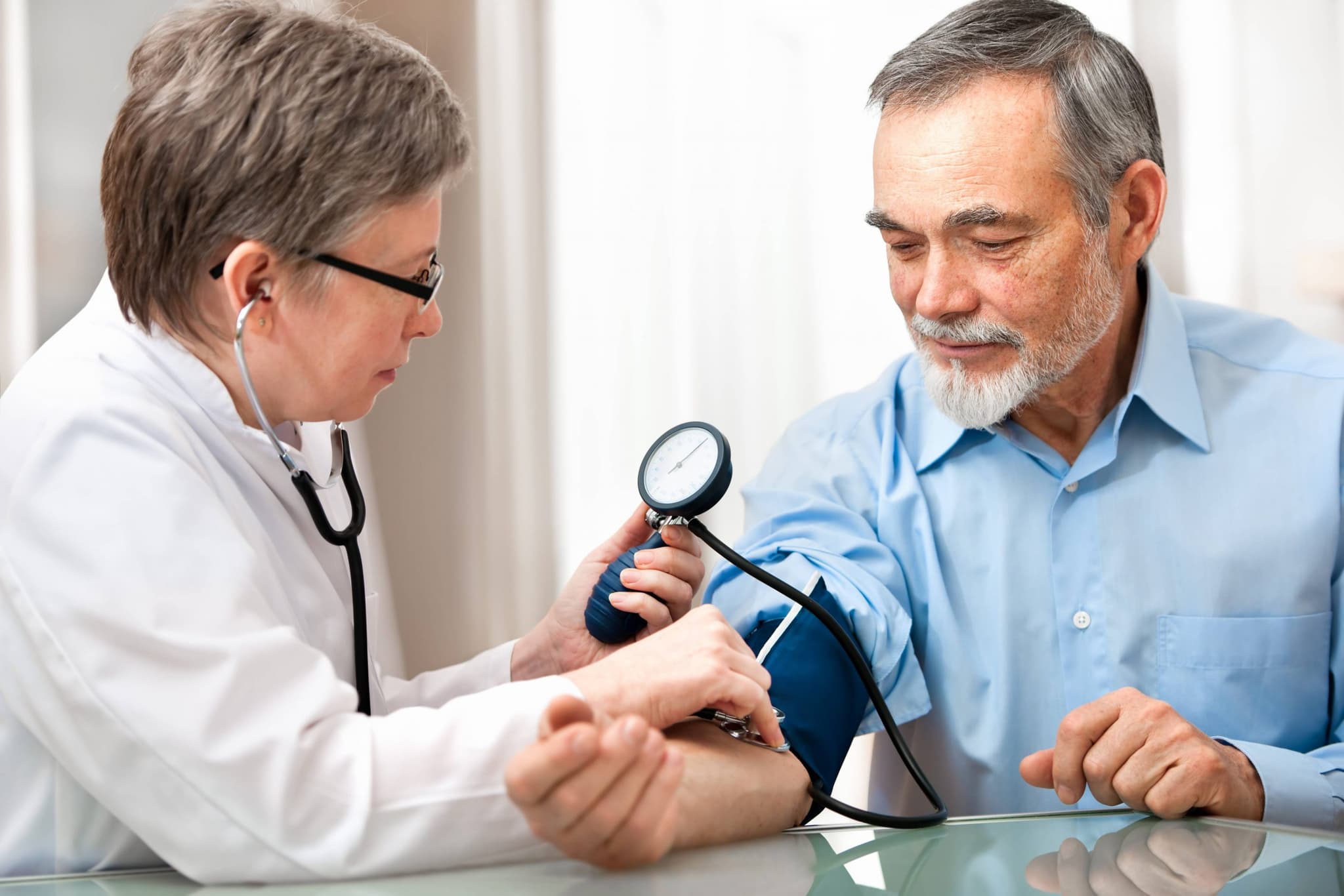 doctor taking pulse of patient