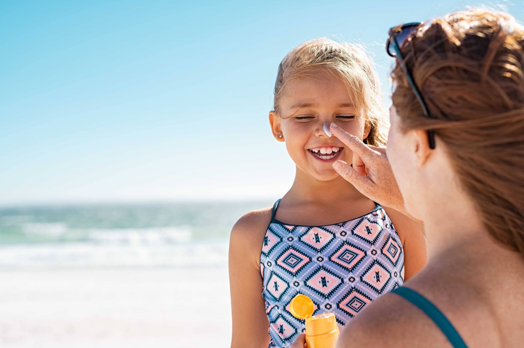 Picture of Mom putting Sun Screen Protection on her child