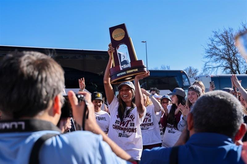 Kayla Elliot holds NCAA trophy after her team wins national championship.