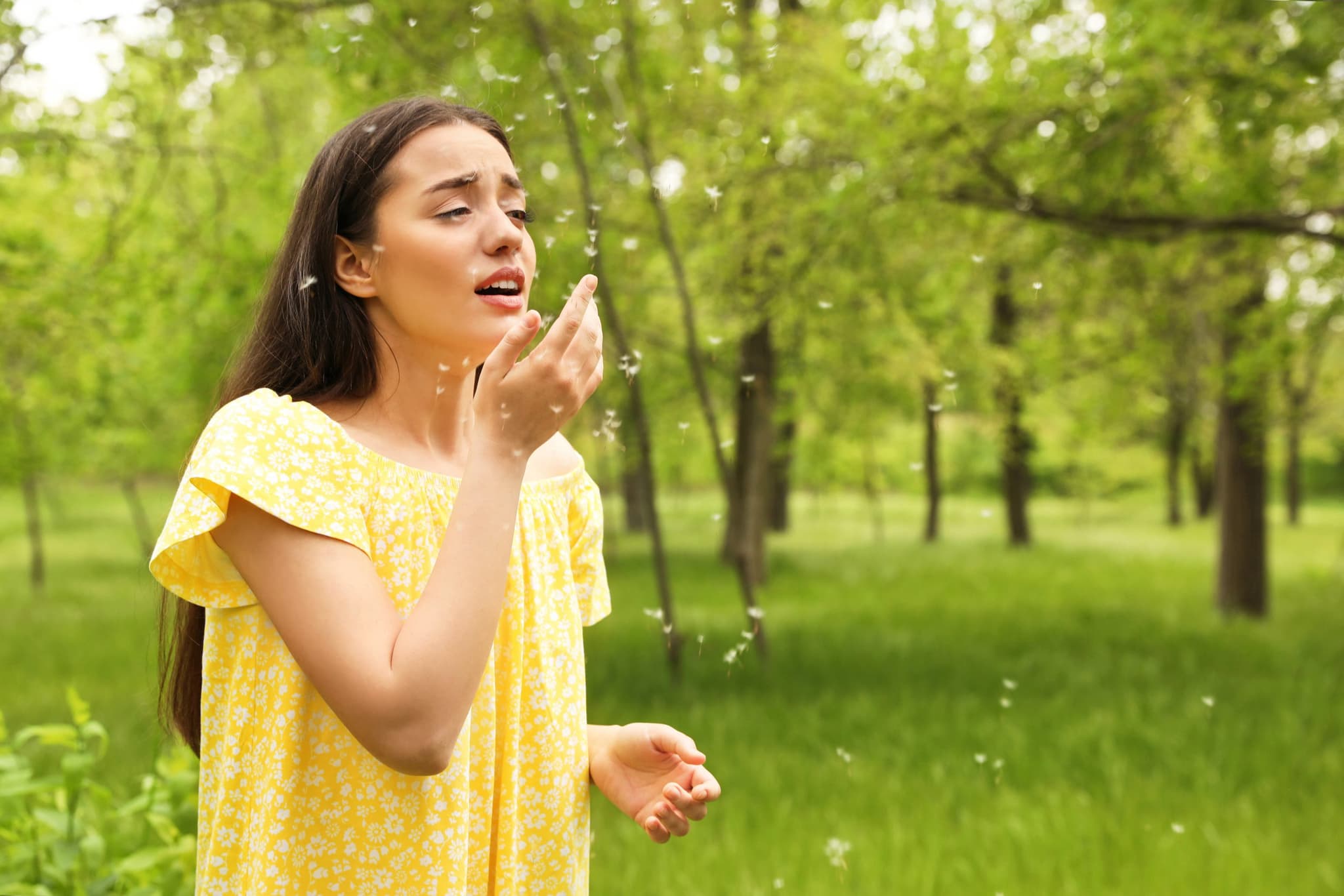 Image of Young woman suffering from seasonal allergy outdoors, space for text