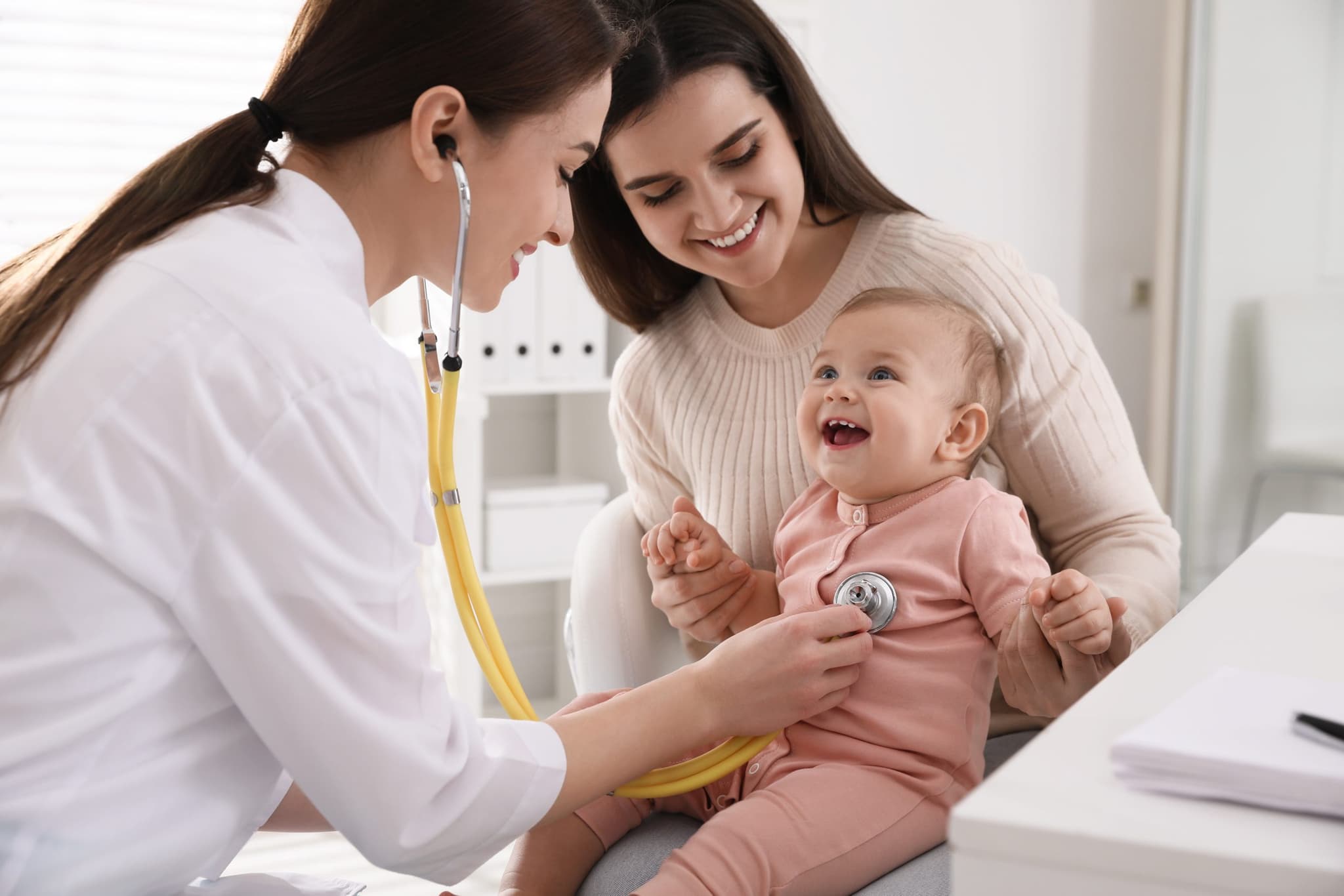 Picture of Mother with her cute baby visiting pediatrician in clinic.