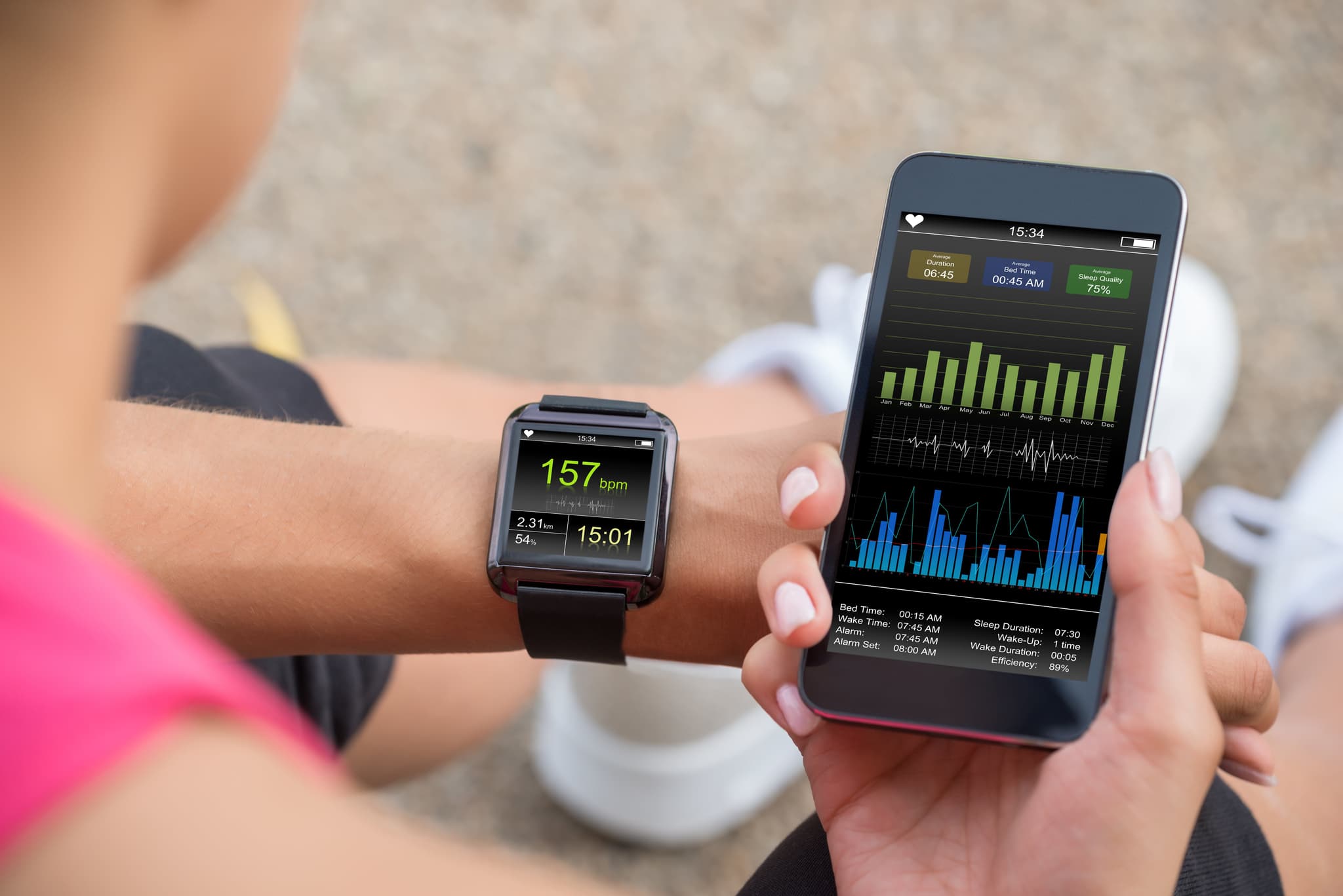 Picture of Female Runner Looking At Her Mobile And Smart Watch Heart Rate Monitor