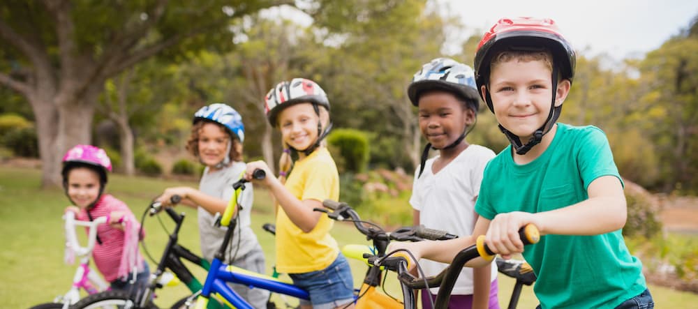 Picture of Smiling children posing with bikes