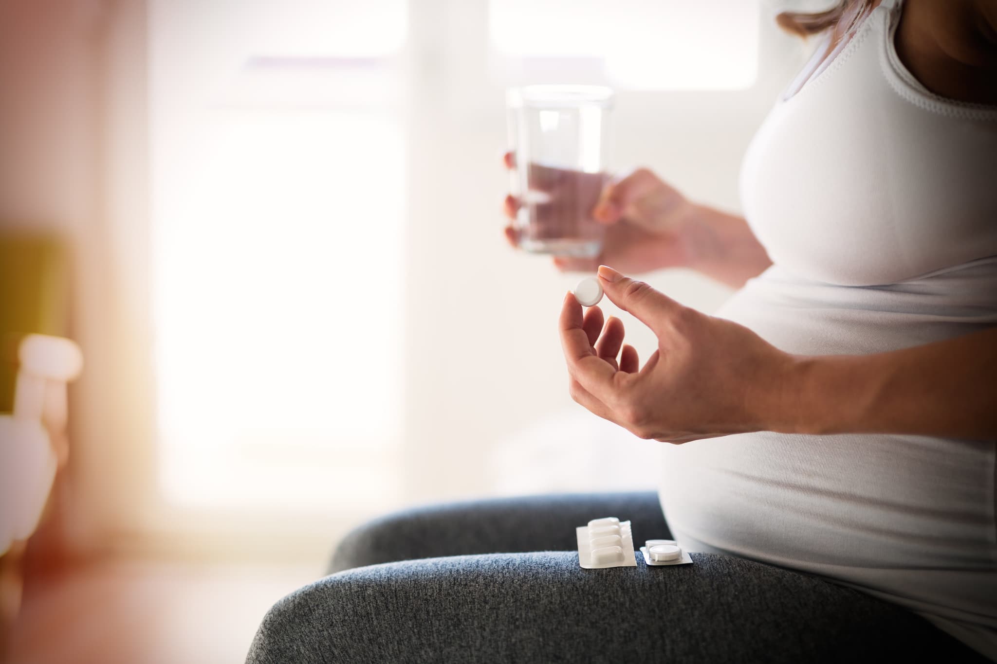 Picture of Pregnant woman taking pill