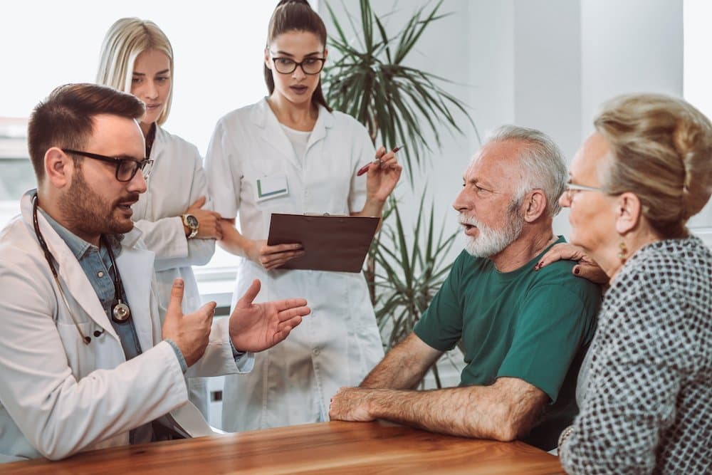 Group of young doctor during home visit senior people