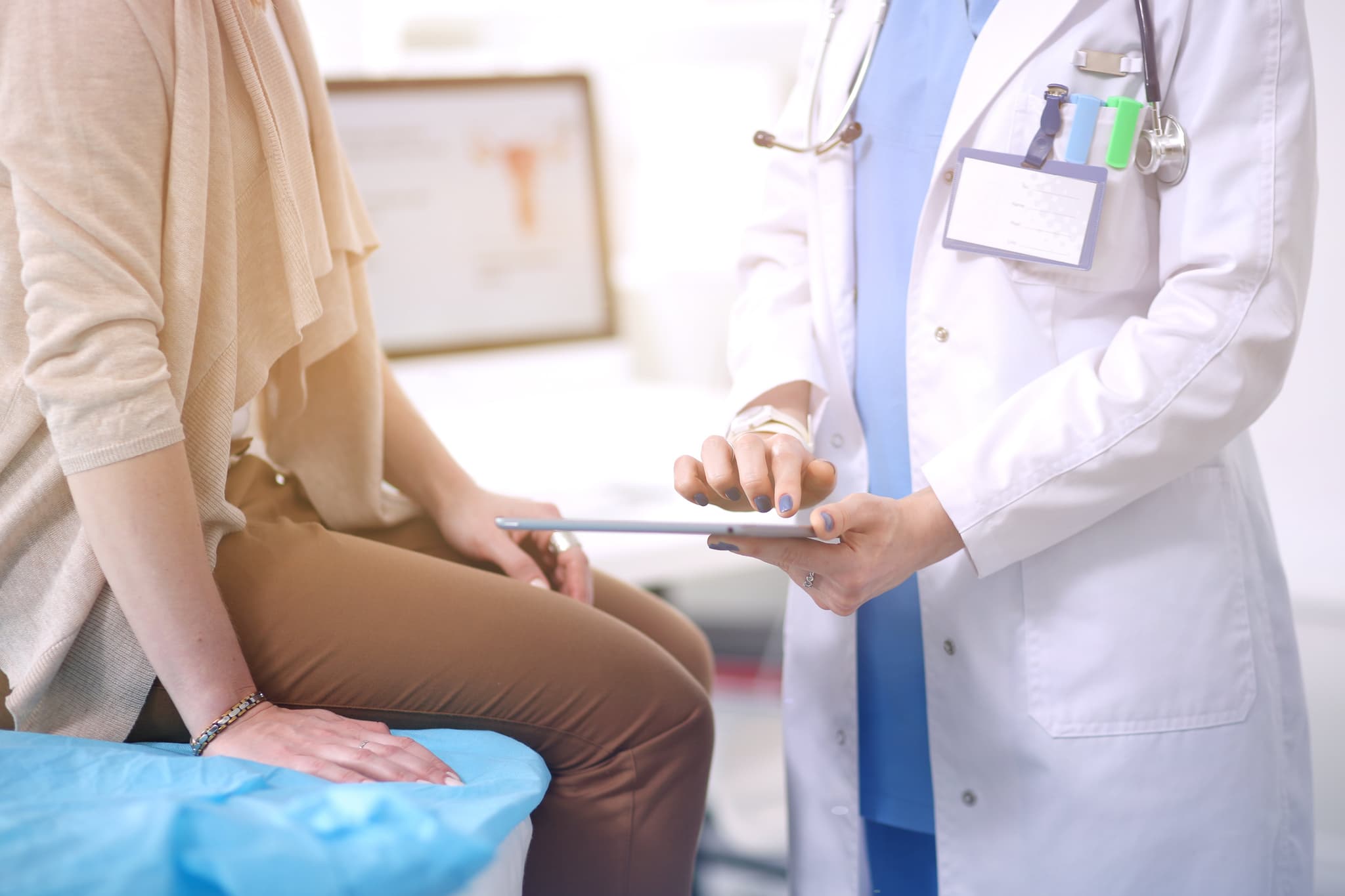 Doctor and patient discussing something while sitting at the table . Medicine and health care concept. Doctor and patient