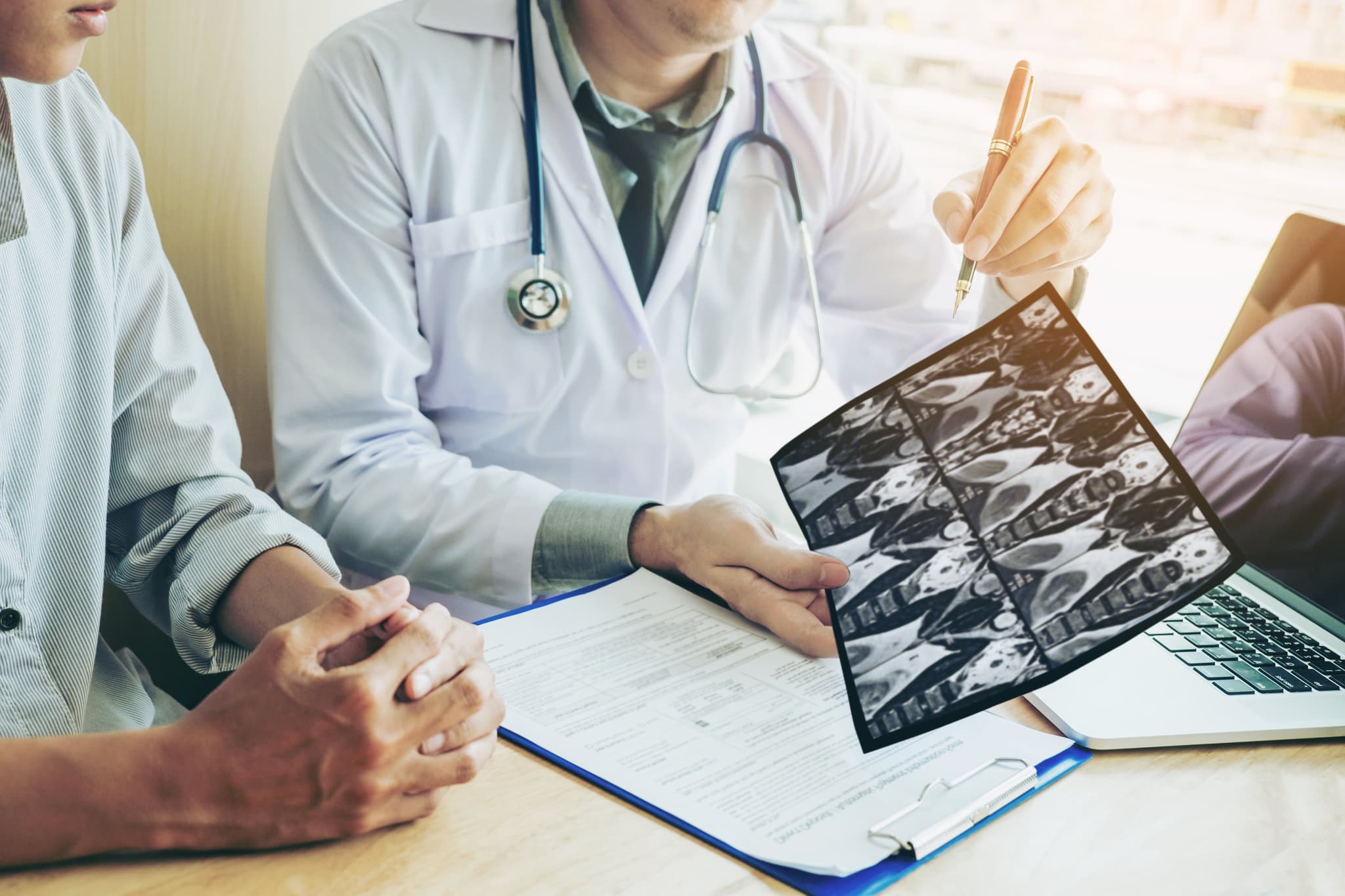 Picture of Doctor consulting with patient presenting results on x-ray film About the problem of the patient