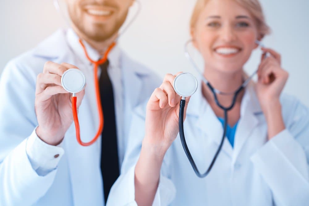 Team Professional Doctor holds stethoscope. Medical assistance or insurance concept The doctor is ready to check the patient and help. The concept of treatment and care for patients.