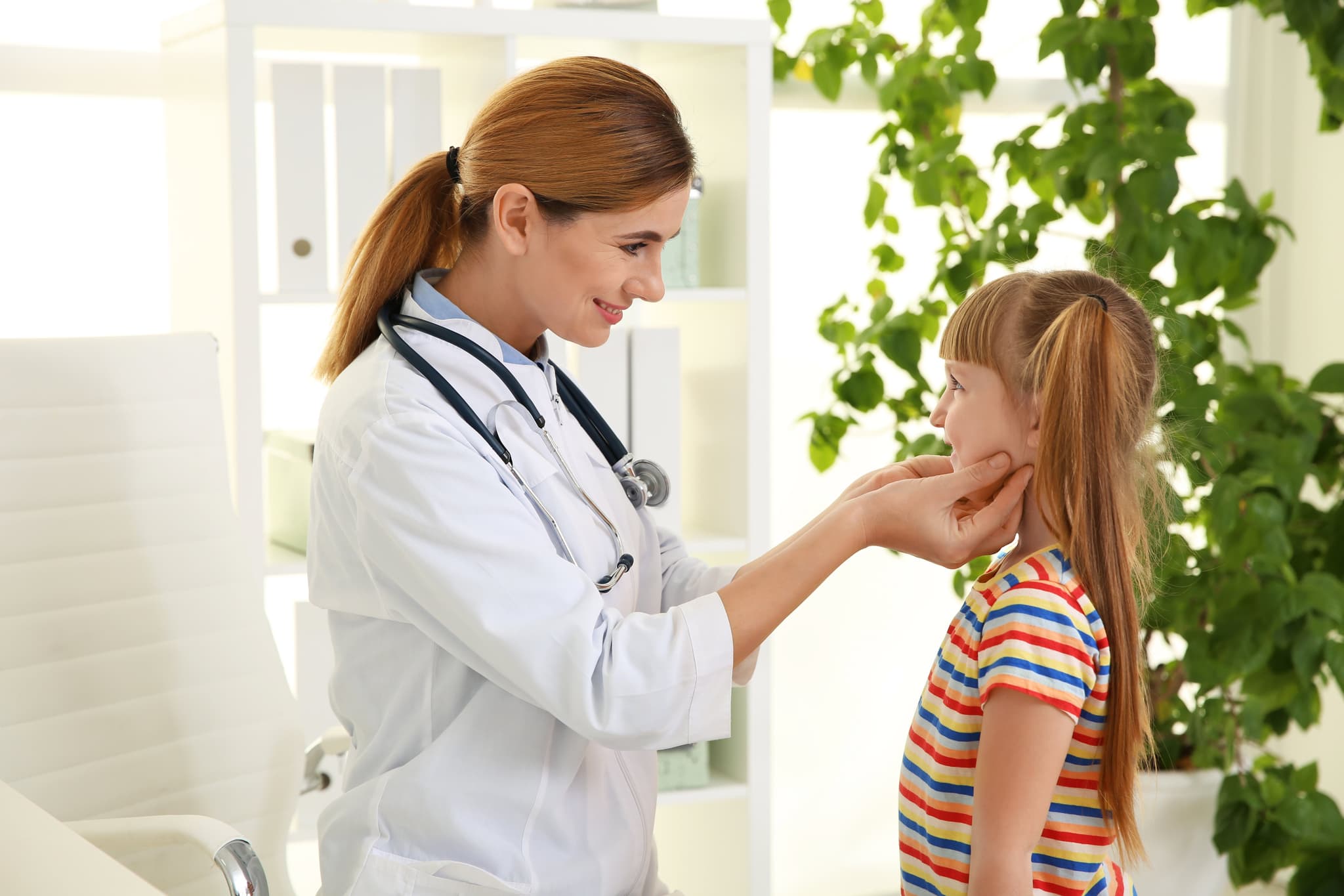 Doctor working with little patient in hospital