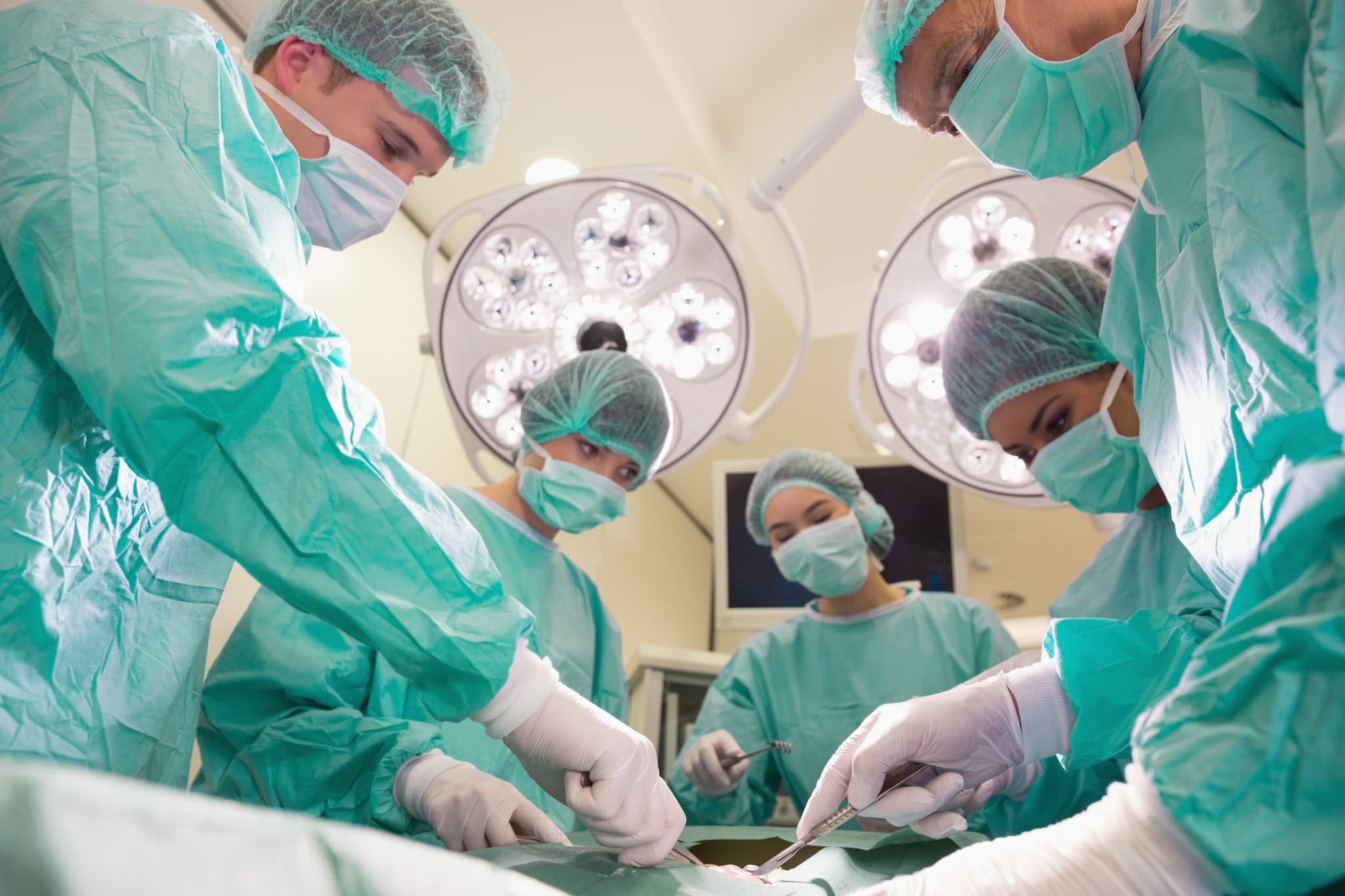 Medical students practicing surgery on model