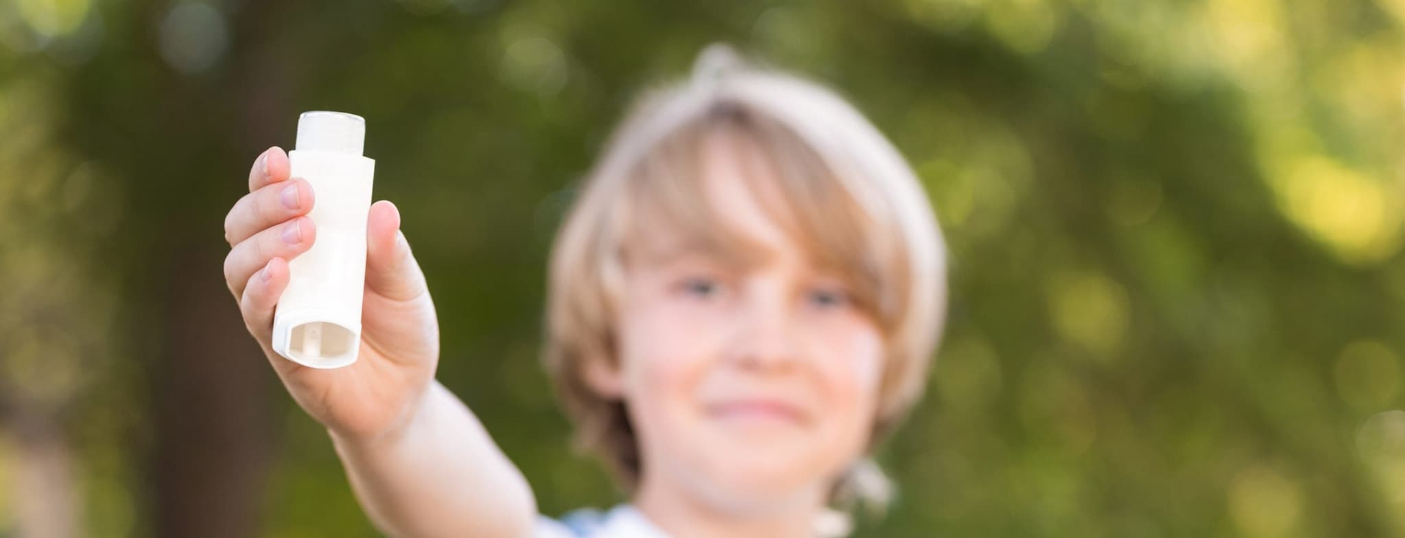 Picture of little boy holding inhaler