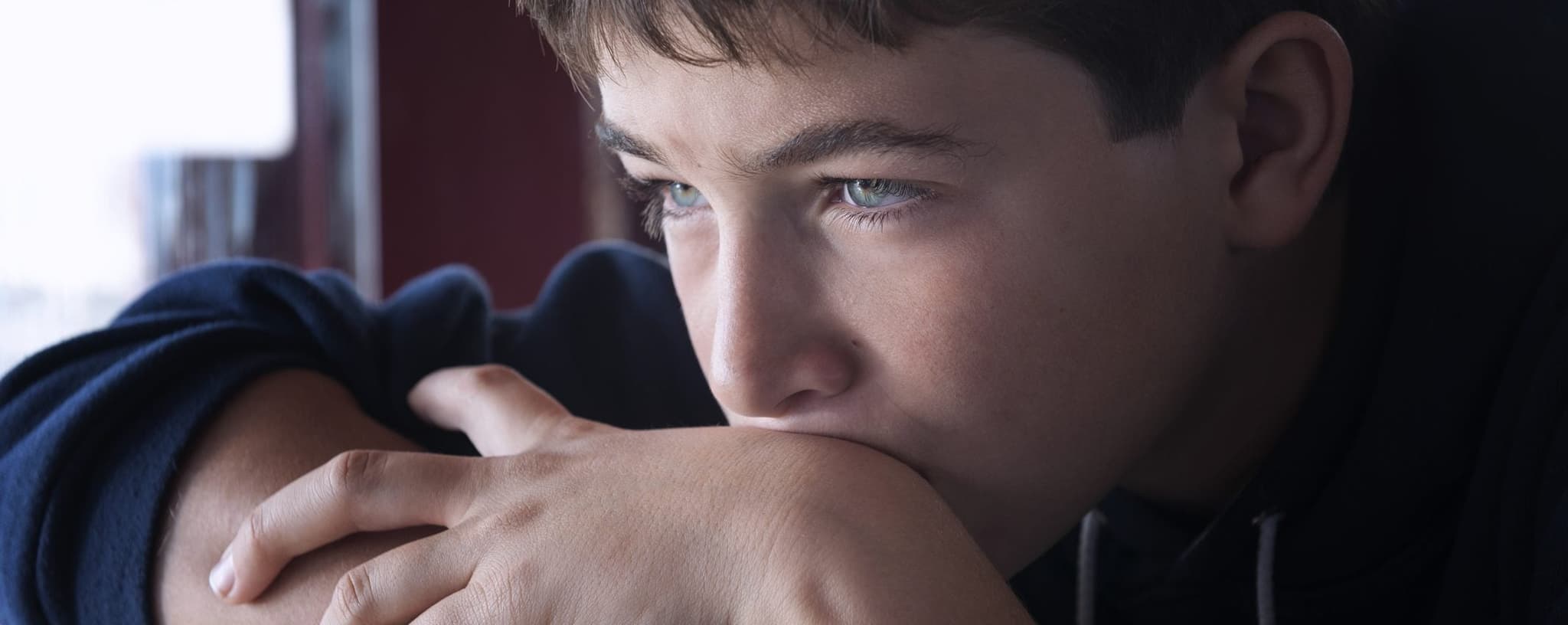 Picture of sad child looking out into distance