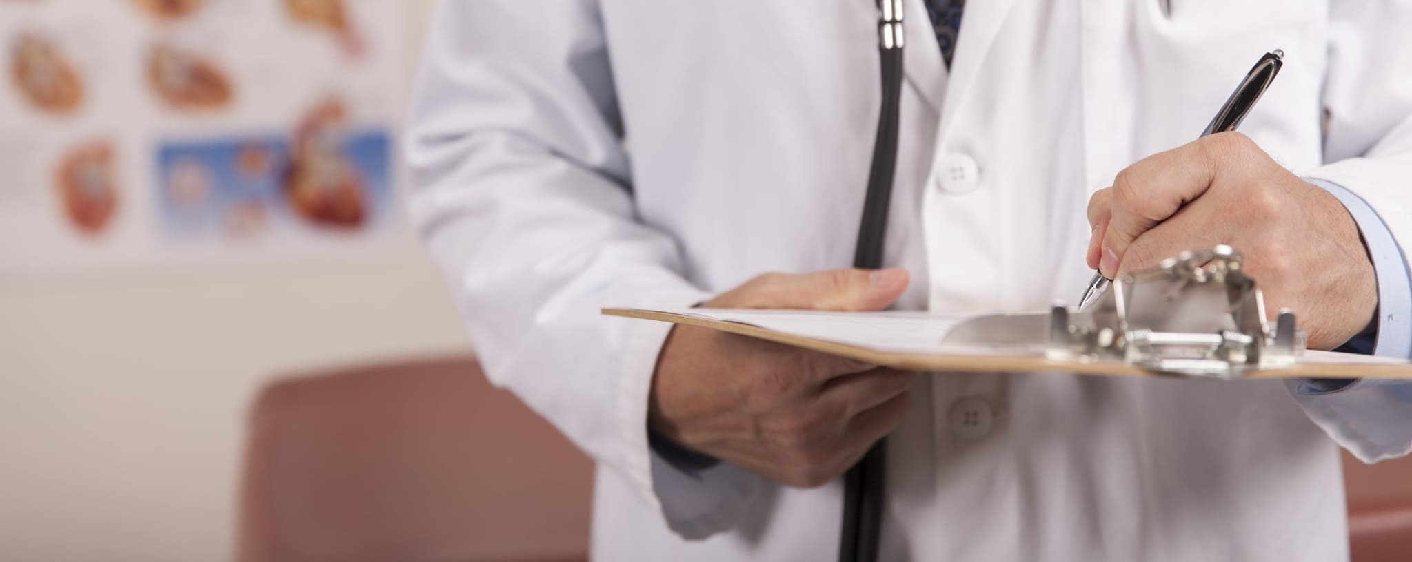 Picture of doctor writing on clip board