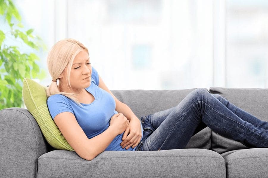 Picture of woman holding stomach in pain