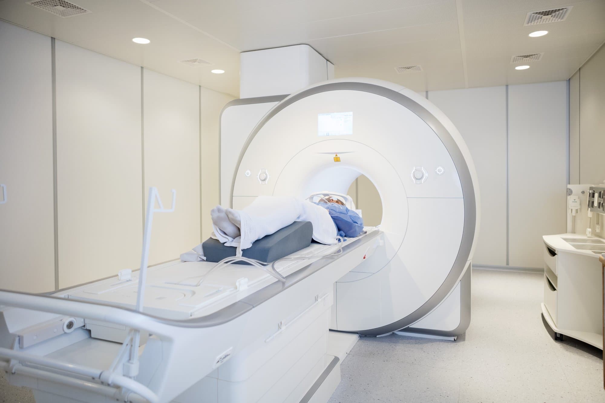 Full length of female patient undergoing MRI scan in hospital