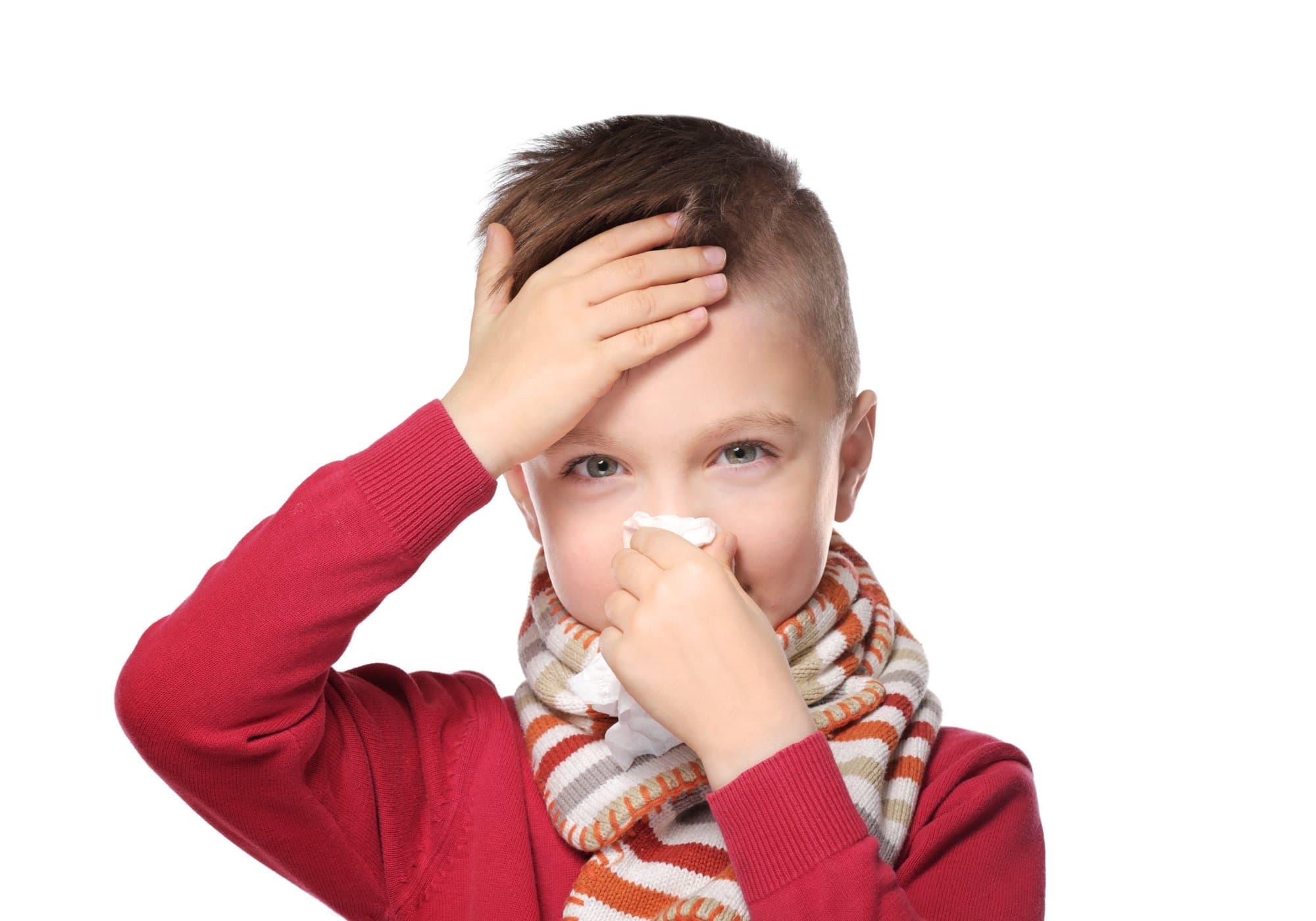 Cute little boy blowing his nose into tissue on white background