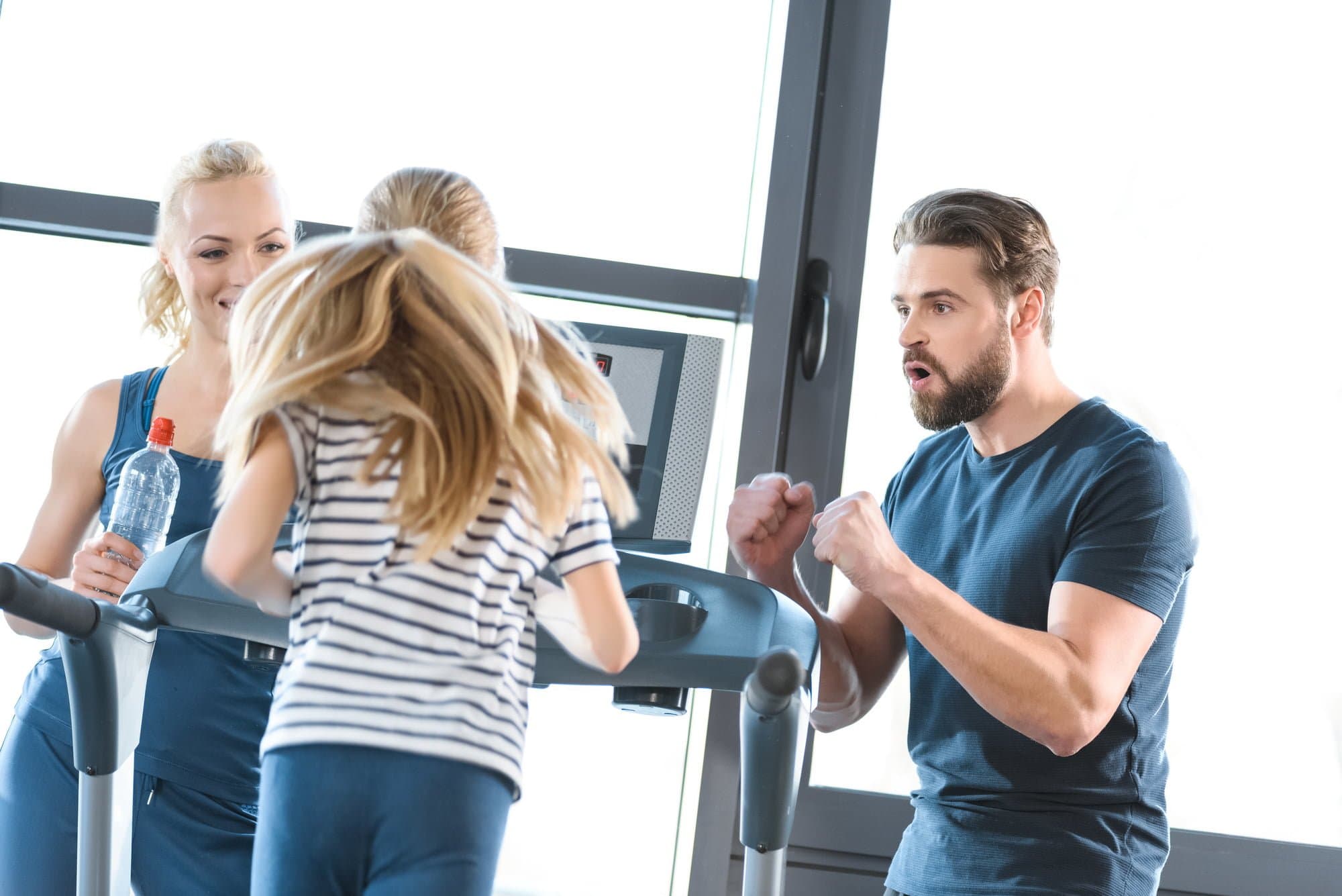 Picture of Parents supporting daughter workout on treadmill